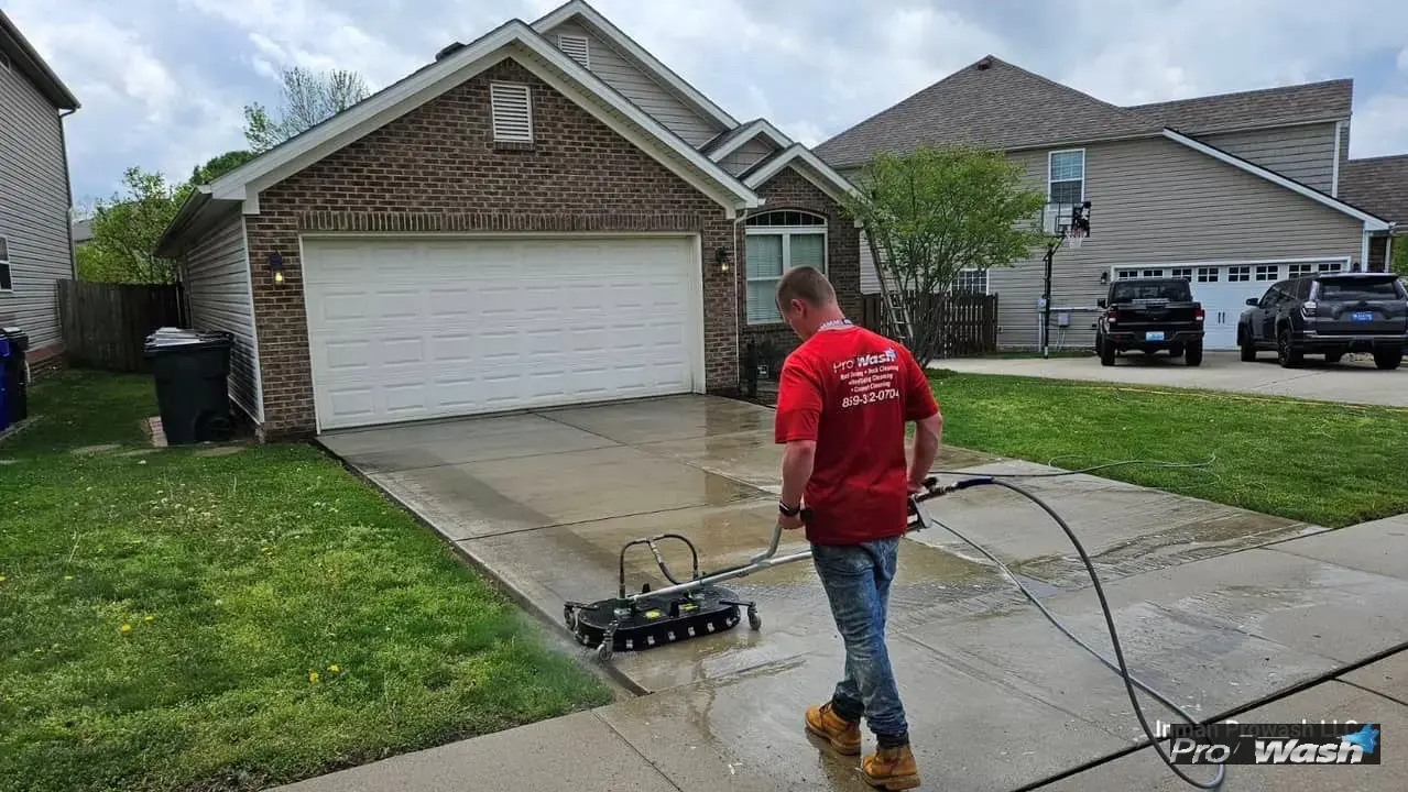 Hot water pressure washing a residential concrete driveway in Lexington, KY.