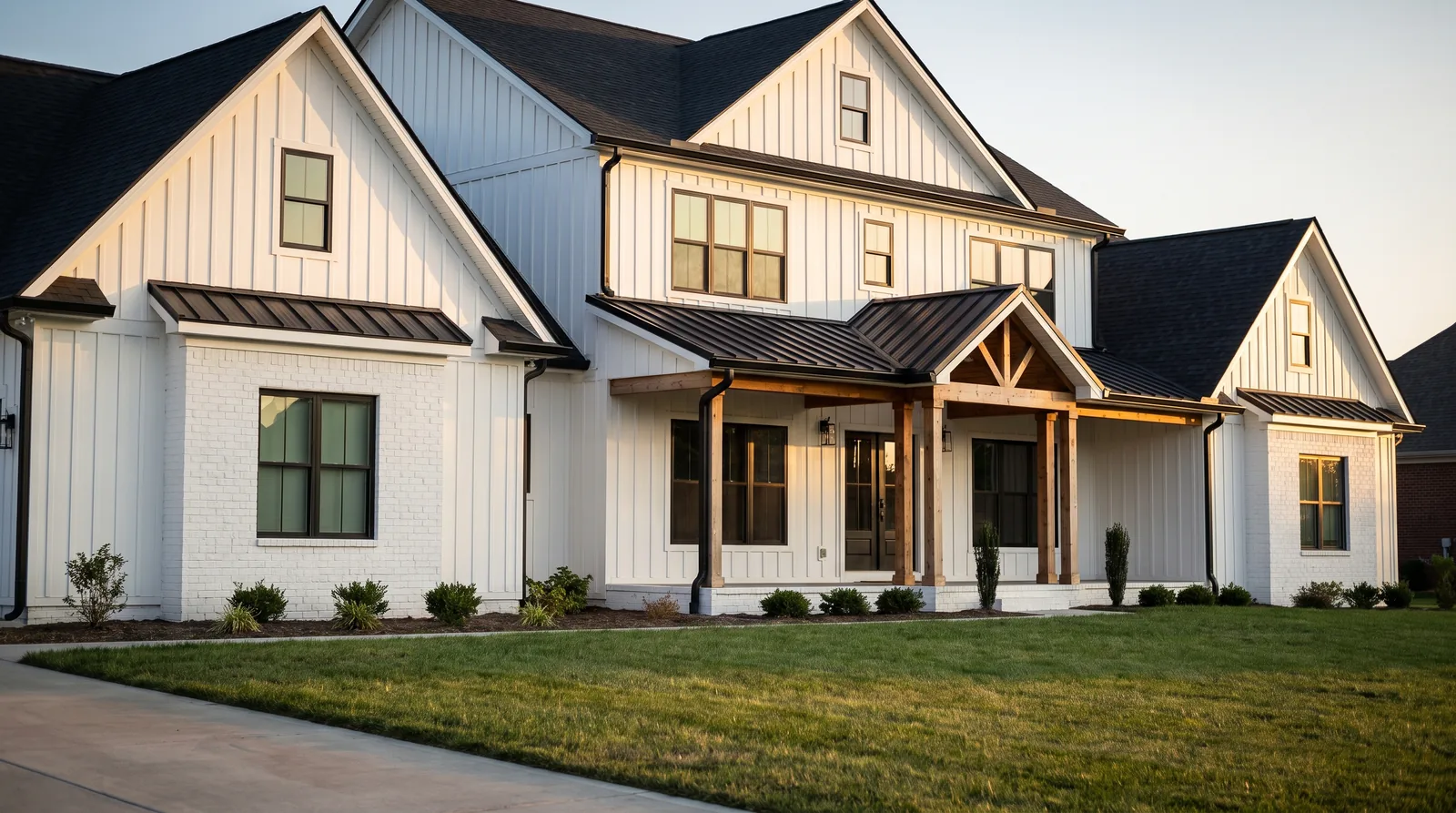 White house with black gutters, black downspouts and black window frames