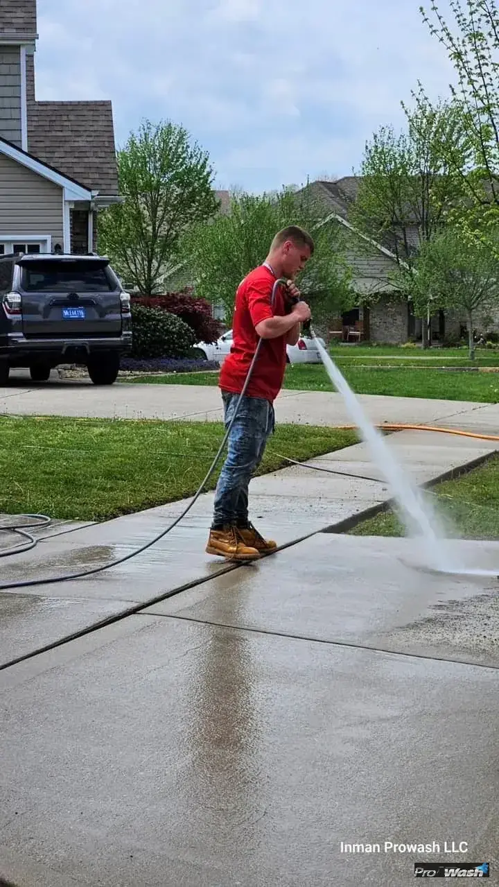 Noah from Inman ProWash rinsing a Georgetown driveway in spring.