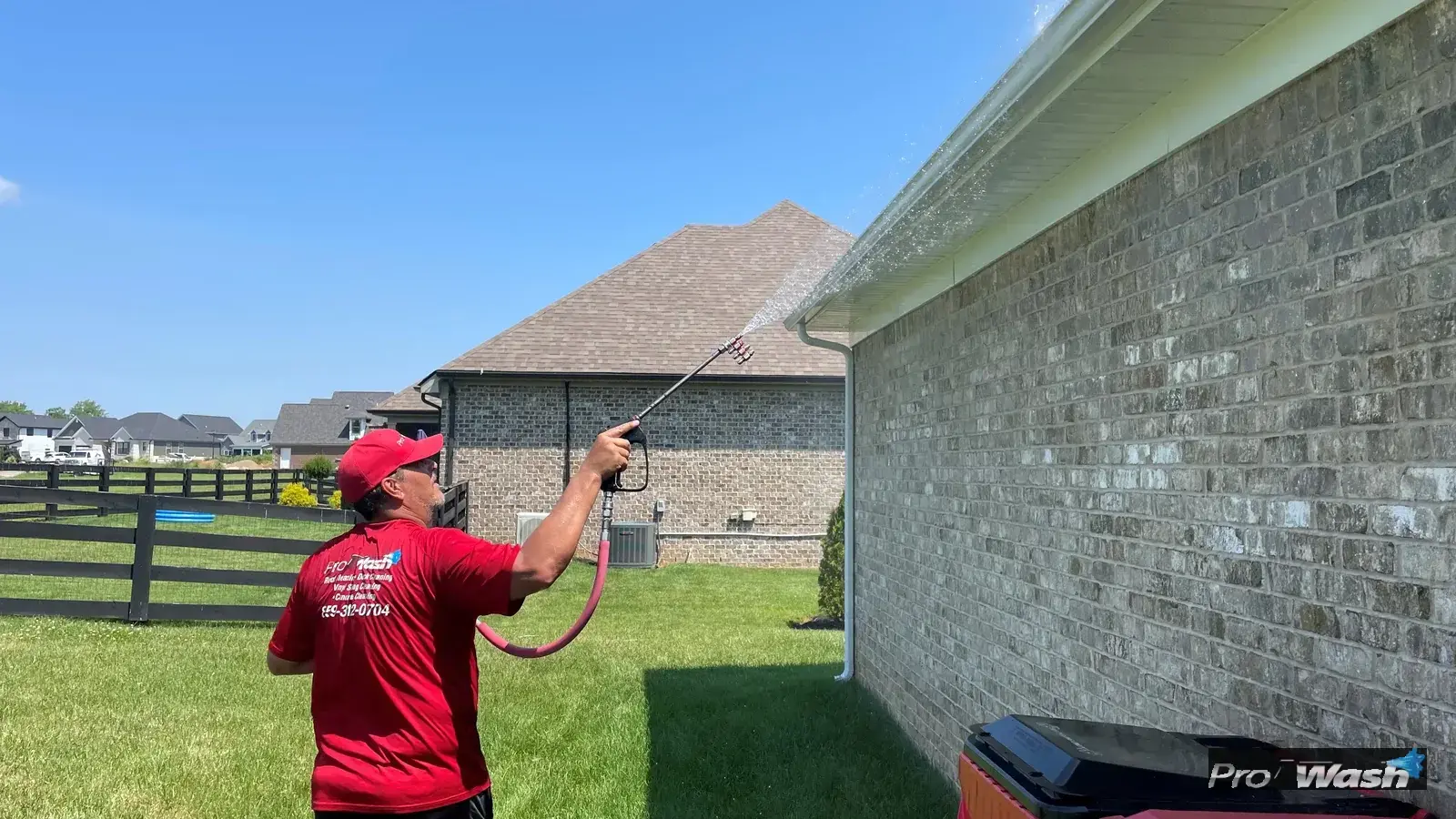 A residential gutter being cleaned of debris by an Inman ProWash technician.