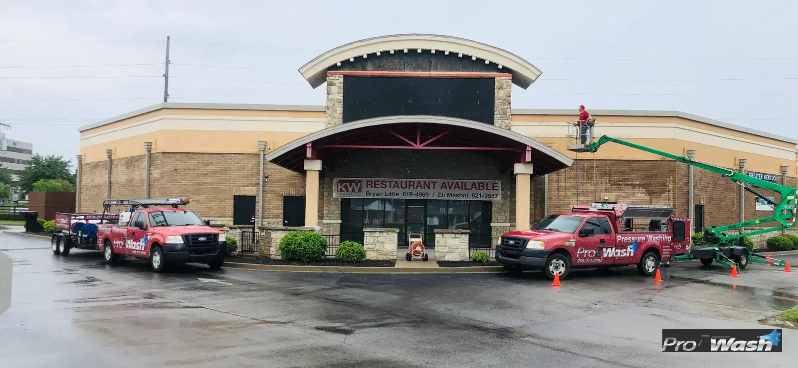 Inman ProWash on a lift cleaning upper exterior of an HOA building.