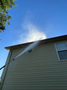 Cleaning two-story exterior gutter from the ground without extension
