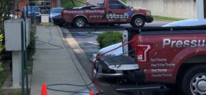 Using multiple trucks can help speed up the process when softwashing a large building