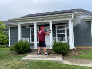 Team applying soft-wash to apartment siding