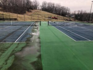 Tennis court cleaning algae and dark staining